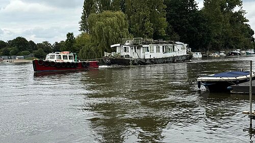 Photo of illegally moored boat being towed.