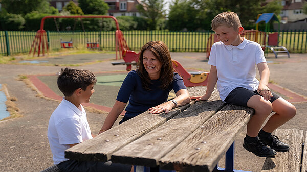 A photo of Monica at a playground with local kids